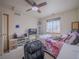 Bright bedroom featuring a window, ceiling fan, and ample space at 319 Mountain View Ave, Fort Lupton, CO 80621