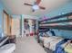 Bedroom featuring a window, ceiling fan, and a black bunk bed at 319 Mountain View Ave, Fort Lupton, CO 80621
