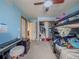 Bright bedroom featuring a window, ceiling fan, and a black bunk bed at 319 Mountain View Ave, Fort Lupton, CO 80621