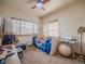Bedroom featuring two windows providing natural light, bed, and a ceiling fan at 319 Mountain View Ave, Fort Lupton, CO 80621