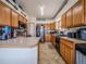 An efficient kitchen with wood cabinets, stainless steel appliances, and lots of counter space at 319 Mountain View Ave, Fort Lupton, CO 80621