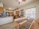 Kitchen boasts wood cabinets, stainless steel appliances, and an adjoining dining area with a wooden table and bench seating at 319 Mountain View Ave, Fort Lupton, CO 80621