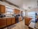 Functional kitchen with oak cabinets and ample counter space at 319 Mountain View Ave, Fort Lupton, CO 80621