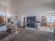 Expansive living room featuring staircase, fireplace, and view to dining area at 319 Mountain View Ave, Fort Lupton, CO 80621