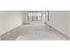 Spacious bedroom with neutral carpeting and large window at 14240 Ivanhoe St, Thornton, CO 80602
