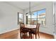 Bright dining area with hardwood floors and a table for four, overlooking the neighborhood at 14240 Ivanhoe St, Thornton, CO 80602