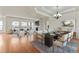 Open dining room with hardwood floors and modern chandelier at 14240 Ivanhoe St, Thornton, CO 80602