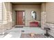 Front porch with a red bench and stone columns at 14240 Ivanhoe St, Thornton, CO 80602