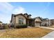 Two-story house with a two-car garage and landscaping at 14240 Ivanhoe St, Thornton, CO 80602