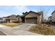 Two-story house with a two-car garage and landscaping at 14240 Ivanhoe St, Thornton, CO 80602