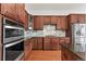 Kitchen with double oven, granite countertops, and ample cabinetry at 14240 Ivanhoe St, Thornton, CO 80602