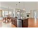Kitchen with large island, stainless steel appliances, and dark wood cabinets at 14240 Ivanhoe St, Thornton, CO 80602