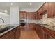 Modern kitchen with dark wood cabinets, stainless steel appliances, and granite countertops at 14240 Ivanhoe St, Thornton, CO 80602