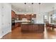 Spacious kitchen featuring an island, stainless steel appliances, and dark wood cabinets at 14240 Ivanhoe St, Thornton, CO 80602