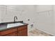 Laundry room with a utility sink and shelving at 14240 Ivanhoe St, Thornton, CO 80602