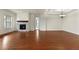 Open living room showcasing hardwood floors and a gas fireplace at 14240 Ivanhoe St, Thornton, CO 80602