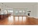 Open concept living area with hardwood floors, kitchen, and fireplace at 14240 Ivanhoe St, Thornton, CO 80602