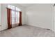 Bright office space with neutral carpet and large window at 14240 Ivanhoe St, Thornton, CO 80602