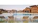 Community pool with lounge chairs and a clubhouse in the background at 14240 Ivanhoe St, Thornton, CO 80602