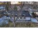 A lovely aerial shot of a home with a dark roof, framed by mature trees at 3318 S Dayton Ct, Denver, CO 80231