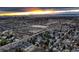 Extensive aerial shot of a city with commercial and residential areas under a vibrant sunset at 3318 S Dayton Ct, Denver, CO 80231