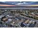 High aerial showing golf course, lake and commercial area near community under a colorful sky at 3318 S Dayton Ct, Denver, CO 80231