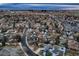 An aerial view of a suburban neighborhood with mature trees, houses, streets, and buildings in the background at 3318 S Dayton Ct, Denver, CO 80231