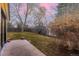Large backyard with a grassy area, bordered by a wooden fence and mature trees, perfect for outdoor activities at 3318 S Dayton Ct, Denver, CO 80231