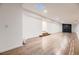 Finished basement featuring hardwood floors, recessed lighting, and a modern fireplace at 3318 S Dayton Ct, Denver, CO 80231
