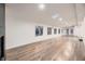 Spacious basement with hardwood floors, ample natural light, and a modern fireplace at 3318 S Dayton Ct, Denver, CO 80231