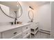 Elegant bathroom with double vanity, marble countertops, and modern lighting fixtures at 3318 S Dayton Ct, Denver, CO 80231