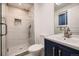 Modern bathroom featuring a glass-enclosed shower with tile surround and vanity with sink at 3318 S Dayton Ct, Denver, CO 80231