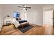 Bright bedroom featuring hardwood floors, a ceiling fan, and a comfortable bed with stylish accents at 3318 S Dayton Ct, Denver, CO 80231