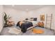 Bright bedroom features contemporary decor, comfortable bedding, and a sleek ladder accent piece at 3318 S Dayton Ct, Denver, CO 80231