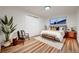Cozy bedroom featuring hardwood floors, natural light, and a comfortable chair with a modern design at 3318 S Dayton Ct, Denver, CO 80231