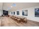 Open dining room featuring a large table, hardwood floors, and skylights for ample natural light at 3318 S Dayton Ct, Denver, CO 80231