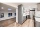 Open-concept kitchen with stainless steel appliances, hardwood floors, and ample storage space at 3318 S Dayton Ct, Denver, CO 80231
