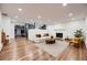 Bright and spacious living room featuring hardwood floors, fireplace, and neutral décor at 3318 S Dayton Ct, Denver, CO 80231