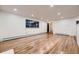 Inviting living room featuring hardwood floors, recessed lighting, and large windows at 3318 S Dayton Ct, Denver, CO 80231