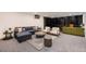 Cozy living room with a comfortable blue sectional, chairs, decorative rug, and stylish built-in shelving at 3318 S Dayton Ct, Denver, CO 80231