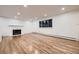 Spacious living room with a marble fireplace, hardwood floors, and a large window with outside views at 3318 S Dayton Ct, Denver, CO 80231