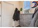 Mud room/entryway with coat rack, storage cabinet, and natural light at 12202 Village Cir, Brighton, CO 80603