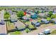 Aerial shot of a fenced backyard with a detached garage and surrounding homes at 2791 Quarterland St, Strasburg, CO 80136