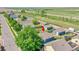Bird's-eye view of a home with a fenced backyard, detached garage, and neighborhood at 2791 Quarterland St, Strasburg, CO 80136
