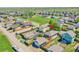 Aerial view of a neighborhood showcasing the fenced backyard with a garage and trampoline at 2791 Quarterland St, Strasburg, CO 80136