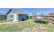 Backyard featuring detached garage, trampoline, and potential for outdoor activities and entertainment at 2791 Quarterland St, Strasburg, CO 80136