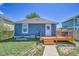 Backyard view featuring a wooden deck, lush grass, and a fenced yard at 2791 Quarterland St, Strasburg, CO 80136