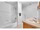 Bright bathroom features a double sink vanity and a shower over tub with white tiling surround at 2791 Quarterland St, Strasburg, CO 80136