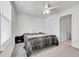 Bedroom featuring ceiling fan, window, and modern gray color palette at 2791 Quarterland St, Strasburg, CO 80136