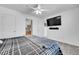 Bedroom featuring ceiling fan, television and view to bathroom and second bedroom at 2791 Quarterland St, Strasburg, CO 80136
